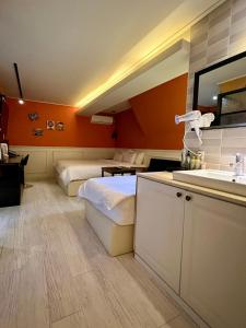 a hotel room with two beds and a sink at Jjak motel in Changwon