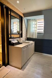 a bathroom with a sink and a mirror at Jjak motel in Changwon +32 photos