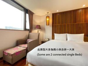 Voodi või voodid majutusasutuse Guide Hotel Taipei Bade toas