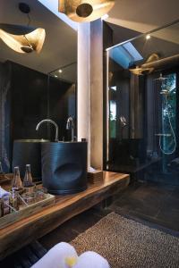 a bathroom with a sink and a mirror at Sanna Ubud A Pramana Experience in Tegalalang