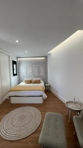 a bedroom with a large bed and a rug at C-10 Vegueta Apartment - Private Rooftop Pool in Las Palmas de Gran Canaria +22 photos