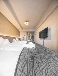 Postel nebo postele na pokoji v ubytování Apartment Hotel 11 Shinsaibashi 2