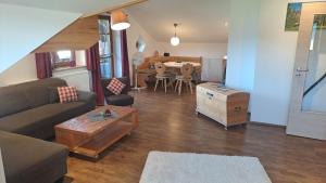 a living room with a couch and a table at Landhaus Brockhaus in Rettenberg