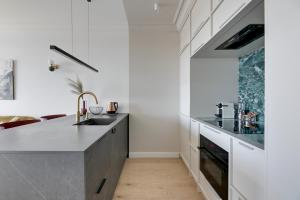 a kitchen with a sink and a counter top at Chlebova River View by Grand Apartments in Gdańsk