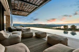 a living room with a large window with a view at Villa Alchaca - New Magnificent Villa with Infinity Pool & Tennis in Kilada