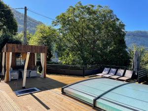 ein Bett auf einer Terrasse neben einem Pool in der Unterkunft gîte à la montagne au calme 