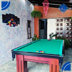 a pool table in front of a building at Hostel&Pousada Equilíbrio in Praia Grande