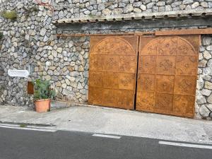a stone building with a large wooden door at Villa Ambra Positano in Positano