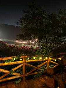 a wooden fence with lights on it at night at La Nostra Terra in Nova Veneza