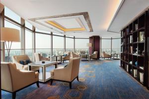 a hotel lobby with chairs and tables and windows at Changzhou Marriott Hotel in Changzhou