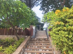 a set of stairs in a garden with a fence at Baan Sandao Unit 303 in Hua Hin