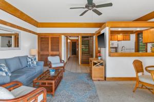 a living room with a couch and a tv at 1Br Poipu Beach Condo, AC, Access to Poipu Beach Athletic Club 437 in Koloa