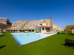 a large swimming pool in front of a large building at Matorral Beach Apartament beautiful ocean view in Morro del Jable