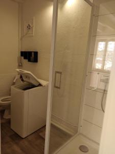 a shower with a glass door in a bathroom at la petite maison d'Albert in La Motte-Saint-Jean