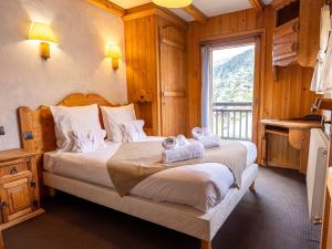 a bedroom with a bed with towels on it at Chalet Philibert in Morzine