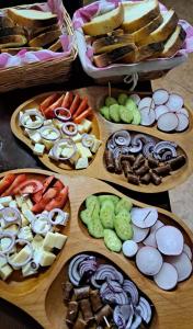 a bunch of different types of food on wooden plates at Pensiunea Maramu in Breb