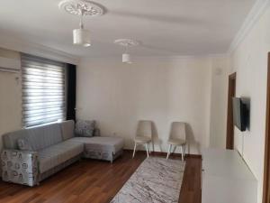 a living room with a couch and two chairs at Old Town Grand Apart Hotel in Antalya