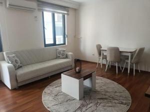 a living room with a couch and a table at Old Town Grand Apart Hotel in Antalya