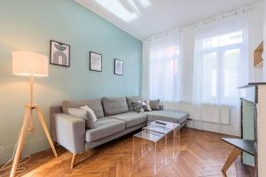 a living room with a couch and a table at 3 bedroom house with garden, near Lille in La Madeleine +30 photos
