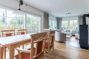 a dining room and living room with a table and chairs at AHOl Ferienhaus in Redewisch