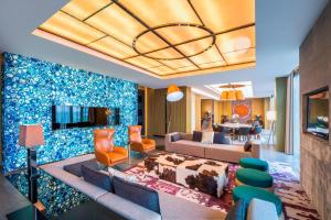 a living room with a couch and a table at Le Meridien Qingdao West Coast Resort in Huangdao