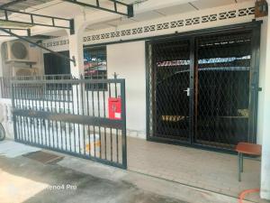 a metal gate in front of a building at HrL Homestay Kangar in Kangar