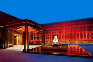 The St. Regis Lhasa Resort في لاسا: مبنى يوجد امامه مزهرية