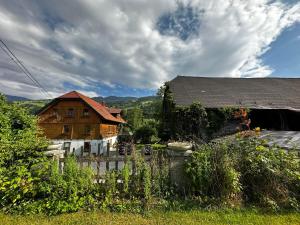a wooden house with a fence in front of it at Klöckhof in Aich
