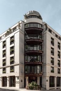 ein Apartmenthaus mit einer Palme an der Fassade in der Unterkunft Hotel Norman Paris in Paris