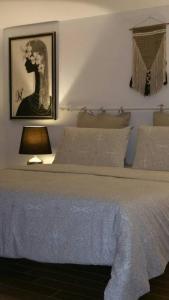 a bedroom with a bed and a lamp and a picture at Cristina’s flat Riccione in Riccione