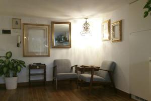 a room with a table and two chairs and a table at Cristina’s flat Riccione in Riccione