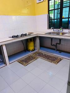 an empty kitchen with a sink and a counter top at ZR Homestay Kemaman with 3 Bedroom 2 Bathroom - 2 Room AC 1 Room Fan - Not Sharing House in Cukai