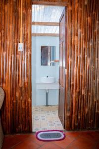 a bathroom with a sink and a mirror at HƯNG THÀNH HOME in Ben Tre