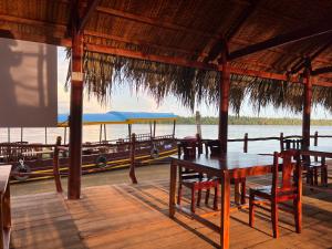 a restaurant with a table and chairs and a boat at HƯNG THÀNH HOME in Ben Tre