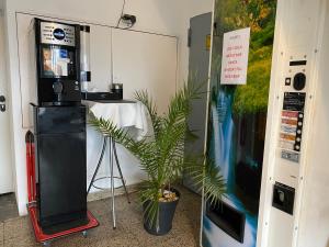 a room with a video game machine and a plant at Top of Hostel &Serviced Aparts SEBO Pension in Fürth