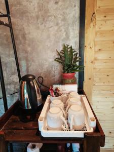 a tray of tea cups and a pot on a table at Farm Hug Aai Yam Boutique Homestay 