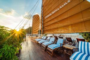 a group of chairs sitting on the deck of a boat at Indochina Sails Ha Long Bay Powered by ASTON in Ha Long