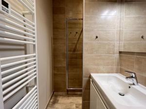 a bathroom with a sink and a shower at Joli T3 rénové ds une villa 1900 in Cauterets