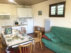 uma cozinha e uma sala de estar com um sofá e uma mesa em Chalet du Renard em Aillon-le-Jeune