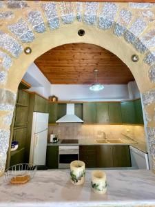 a kitchen with a table with two stools on it at Mani Spot -cereus in Areopoli