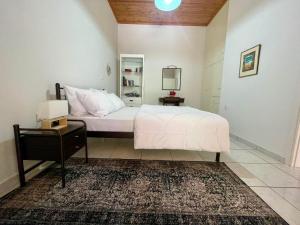 a bedroom with a white bed and a mirror at Mani Spot -cereus in Areopoli