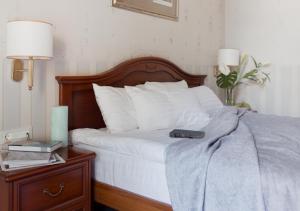 a bed with a remote control sitting on top of it at Continental Hotel in Odesa +50 photos