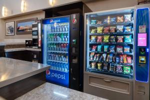 a soda vending machine in a store with drinks at Best Western PLUS Port O'Call Hotel in Calgary