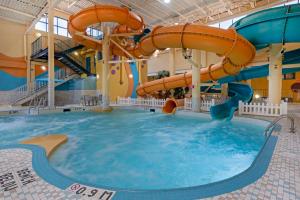 a large indoor swimming pool with a water slide at Best Western PLUS Port O'Call Hotel in Calgary