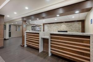 a lobby with a reception counter in a hospital at Best Western PLUS Port O'Call Hotel in Calgary