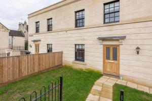a house with a wooden door and a yard at 1 Victoria Place in Bath +14 photos