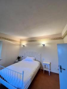 にあるBorgo BiancoMatilde - Locandaのベッドルーム(白いベッド1台、テーブル付)