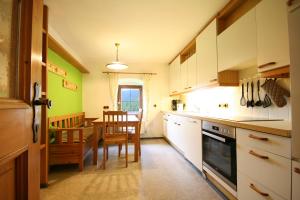 a kitchen with a table and a dining room at Almliesl BREI-708 in Breitenbach am Inn