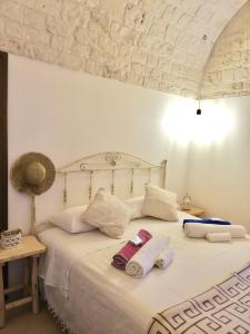 sypialnia z łóżkiem z ręcznikami w obiekcie Trulli Bosco Selva w Alberobello