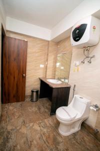 a bathroom with a toilet and a sink at Tiara Regency Gangtok in Gangtok